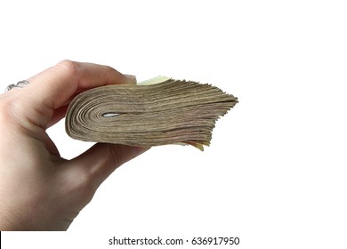 A bundle of money in hand isolated on white background - Shutterstock ID 636917950