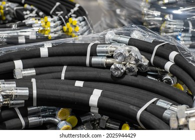 Bundle of new high pressure hydraulic hoses in a package. Hydraulic hoses with yellow plugs.