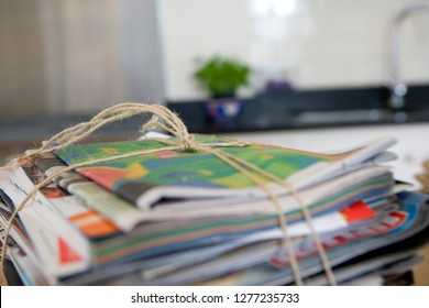 Bundle of newspapers tied with string for recycling