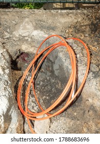 Bundle Orange Fiber Cable On A Construction Site. Building Of Lines Of Metallic And Fiber Optic Cables Of Communication Network Connection