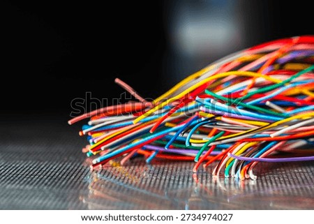 Bundle of thick colorful electrical cables used in telecommunication and information systems. Industrial wiring representing network infrastructure, power distribution, and technical connectivity.