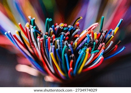 Bundle of thick colorful electrical cables used in telecommunication and information systems. Industrial wiring representing network infrastructure, power distribution, and technical connectivity.