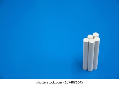 Bundle of white chalks with blue background