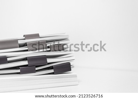 bundles bales of paper documents. stacks packs pile on the desk in the office. waste paper, paper trash