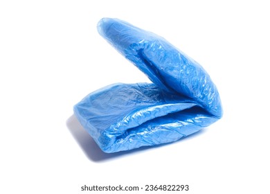 bundles of blue shoe covers isolated on white background. - Shutterstock ID 2364822293