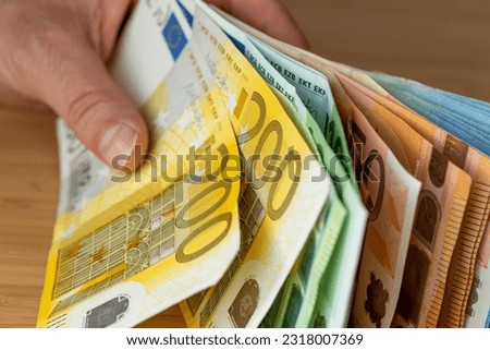 Bundles of euro money, bundle of banknotes held in a hand, Financial concept, Euro zone, Currency of the European Union