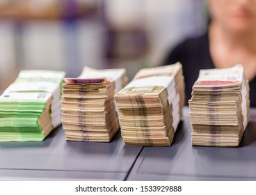 Bundles of euro € money financial picture, female cash desk worker counting money, euro banknote in treasury department for cash machine refill