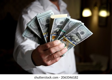 bundles of money dollars in the hands of a businessman