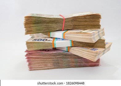bundles of Ukrainian money, stacks of hryvnia, 200,500. money concept. Lots of banknotes. Side view. White background