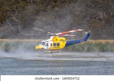 Bundoora, Australia - December 30, 2019:Bell 412 Helicopter Filling With Water To Fight A Bushfire In The Melbourne Suburb Of Bundoora. 