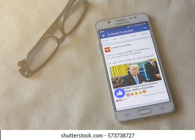 BUNG KAN, THAILAND - FEBRUARY 05, 2017: Smart Phone Display Facebook News Feed About Donald Trump With Like Button