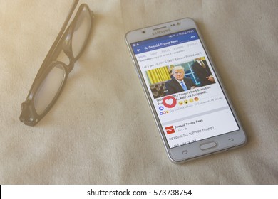 BUNG KAN, THAILAND - FEBRUARY 05, 2017: Smart Phone Display Facebook News Feed About Donald Trump With Love Button