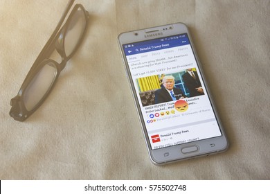 BUNG KAN, THAILAND - FEBRUARY 05, 2017: Smart Phone Display Facebook News Feed About Donald Trump With Angry Emoticon