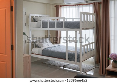Bunk bed. A dormitory with bunk bed bu the window. Window light. film grained filter.