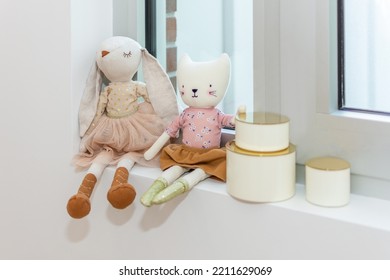 Bunny And Cat Plush Toys On Window Sill