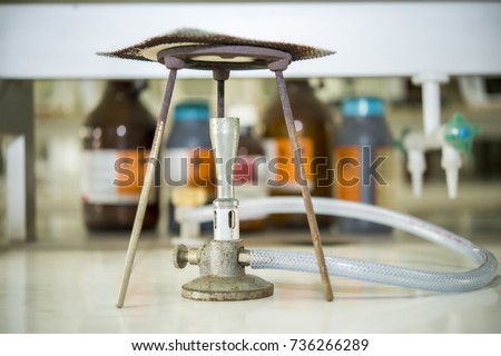 bunsen burner, tripod and wire gauze  in the chemical laboratory.