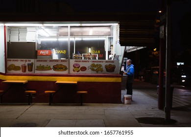 Burbank, California - April 15 2019: A Man Buys A Donut At A Vintage Donut Shop At Night.