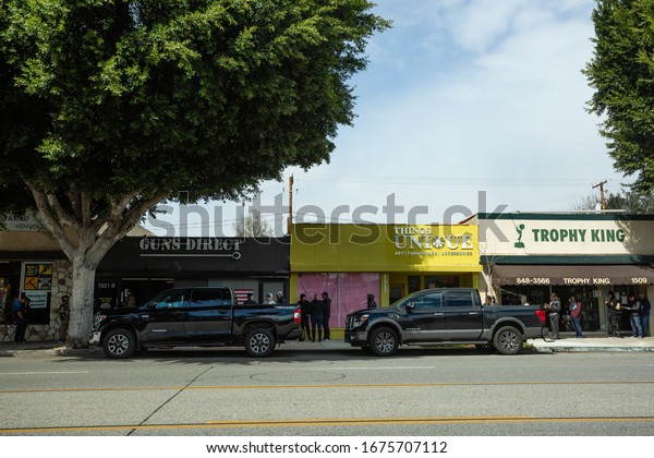 Burbank, California - March 17 2020: People line\
around the street at the gun store, waiting to buy guns during the\
coronavirus (Covid-19)\
panic.