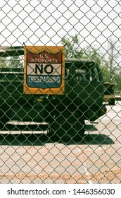 Burbank, California - May 1 2019: A US Property Sign Outside Of A National Guard Base, With A Military Vehicle In The Background. (35mm Film.)