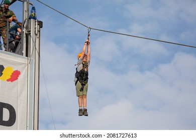 Burcht, Antwerp, Belgium 26 September 2021 : Boy Hanging On Rope During Rappel Abseiling And Soldier Watching During Belgian Army Demonstration Days In Antwerp