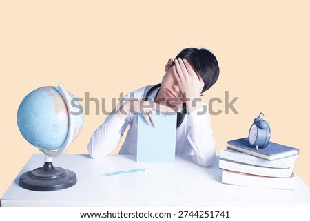The Burden of Study: A student in deep despair, overwhelmed by the weight of academics, leans heavily on books and an academic globe, expressing the strain of intellectual pursuit.