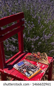 Burdur / Turkey - July 7, 2019 ; Book Concept For School. The Woman Reading Charles Dickens,A Tale Of Two Cities Book And Fan On The Red Wooden Table At The Lavender Field.