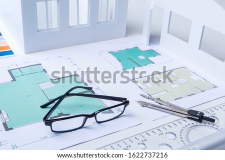 Bureau of Architecture. Drawings on the desk of an engineer. Workplace of the architect. Design of residential premises. Development of drawings of premises. Layout of the rooms. Building.