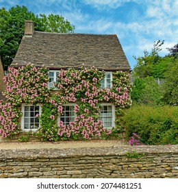 Burford, Gloucestershire, UK, July 18th, 2021, A Small Cottage In The Cotswolds Covered With Climbing Roses In Summer.