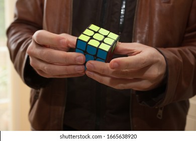 Burford, Oxfordshire, UK 03 04 2020 Man Playing With Rubix Cube