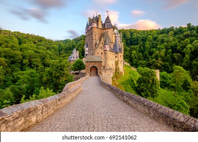 Burg Eltz castle in Rhineland-Palatinate state at sunset, Germany. Construction started	prior to 1157.