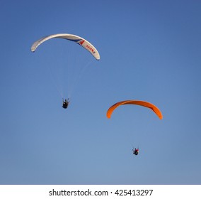 Burgas - August 4: Photo by air. Red and white paragliders flying against the background of blue sky on August 4, 2013, Burgas, Bulgaria
