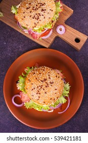 Burger With Beef, Bacon, Tomato, Cheese, Lettuce And Onion And Parmesan Eggplant. View From Above, Top Studio Shot