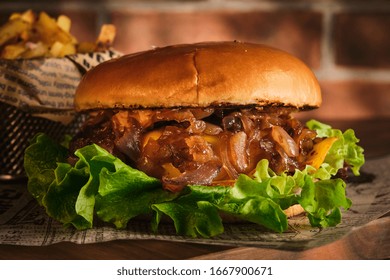 Burger with beef and caramelized onions on a wooden board. Cheeseburger with onion and beef. Juicy Delicious Homemade Burger - Powered by Shutterstock