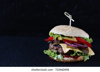 Burger with a beef from a beef, tomatoes, cheese, lettuce leaves. copy space. place for text. - Shutterstock ID 723460498