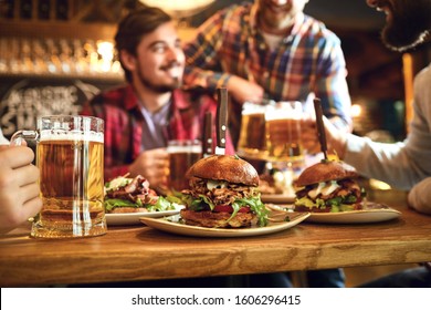 Burger With Beer On The Table In A Bar Pub.