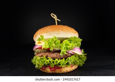 Burger with cheese. Cheeseburger on dark background - Shutterstock ID 1941017617