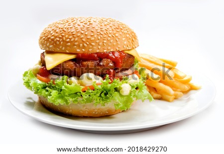 burger with cheese ketchup salad mayonnaise and french fries on plate and white background.