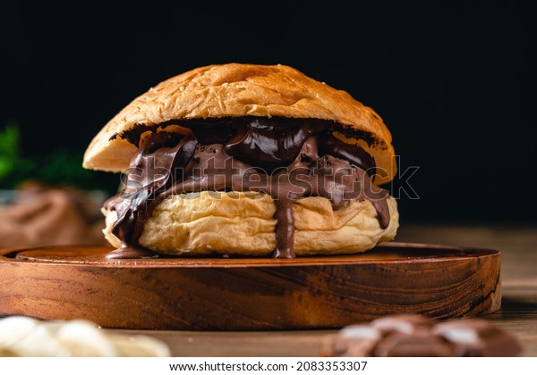 burger with chocolate ice cream.Ice cream sandwich on\
wood background. 