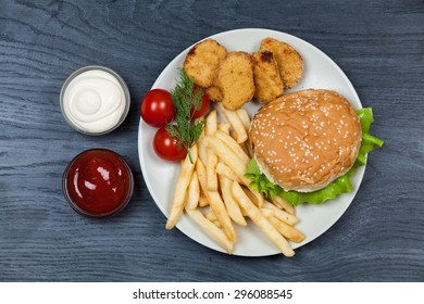 burger with french fries on wooden background