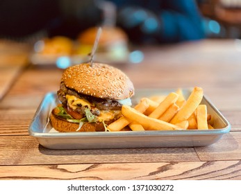 Burger With Fries On Food Tray In Restaurant.