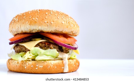 Burger full face with vegetables, spices and fries. Meat hamburger. Hamburger with knife. Beef hamburger. Organic hamburger