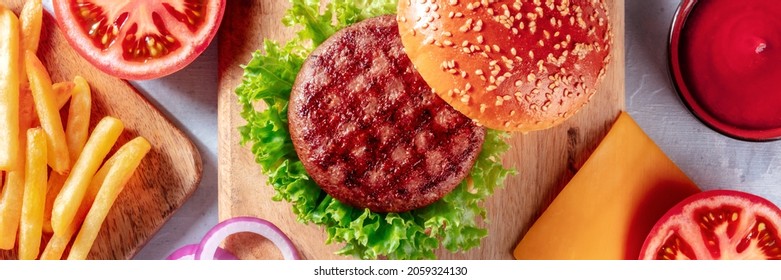 Burger Ingredients Panorama, Shot From Above. Hamburger Beef Patty, French Fries, Green Salad, Ketchup, Top Shot