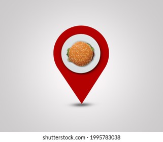 Burger location symbol of a pin. A burger shape on location pin concept for customer visit. Restaurant Destination. Design isolated red background.