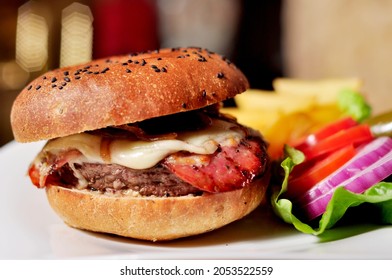 Burger Made In A Restaurant In Monterrey. It Contains Beef, Cheese, Onion, Tomato.