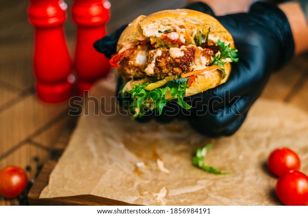 Burger with\
meat cutlet. Divided into two by\
hands