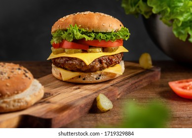 Burger On The Board On A Dark Background