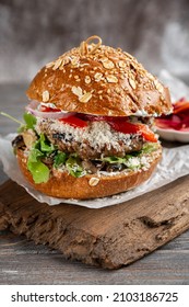 Burger on the brown wooden board.  - Shutterstock ID 2103186725