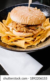 Burger with pulled meat and corn chips