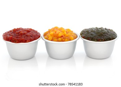 Burger Relish Selection Of Red Tomato, Sweetcorn And Green Gherkin  In Metal Serving Dishes, Over White Background.