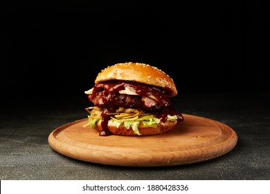 Burger With Steak On Wooden Plate Dark Background